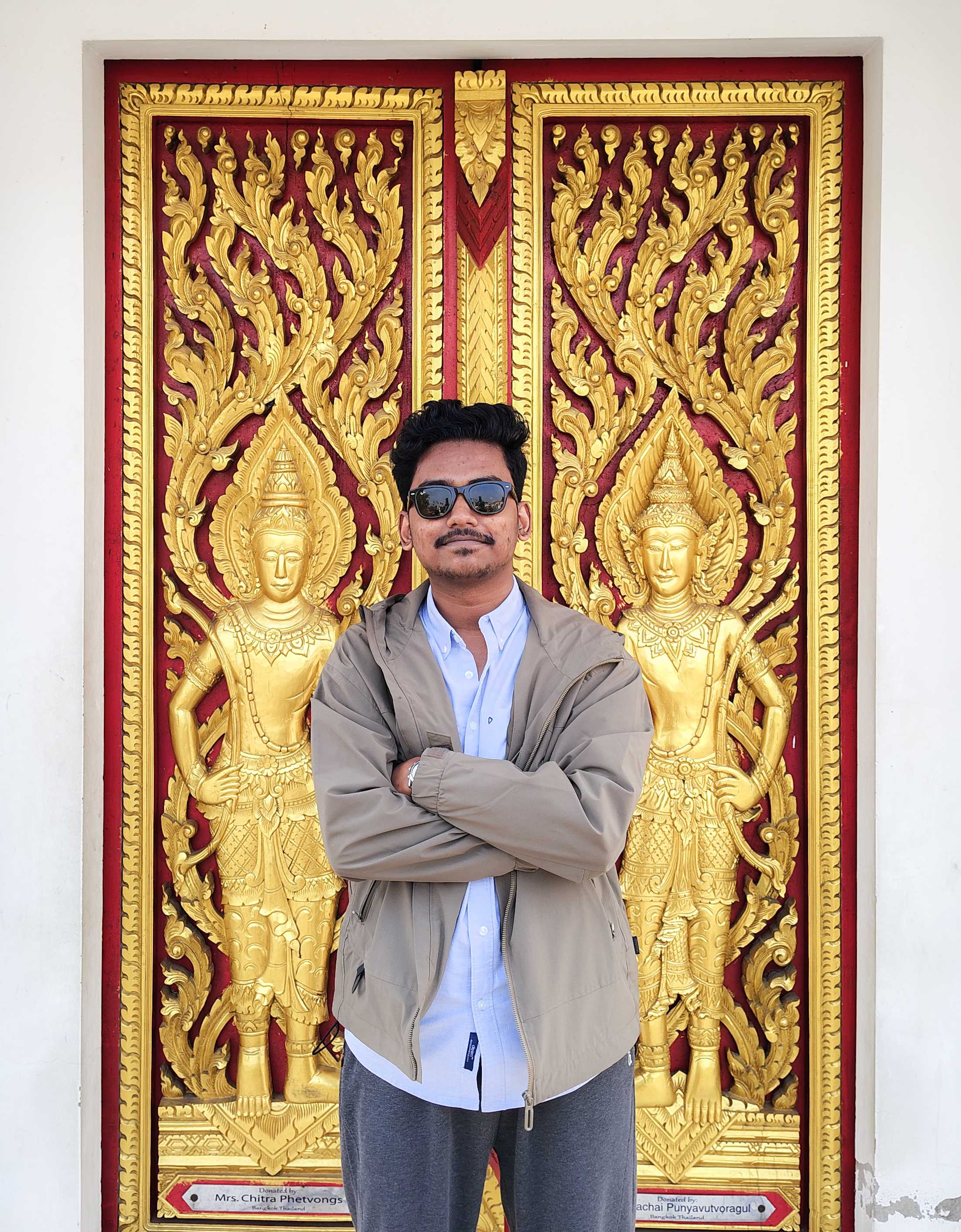 Portrait of Shafin in front of an ornate golden doorway